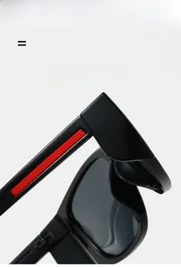 Detail of polarized sports sunglasses showing sleek black frame and red side temple design