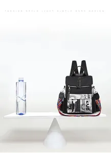 Lightweight black nylon backpack weighing only 0.35kg shown on a scale for comparison