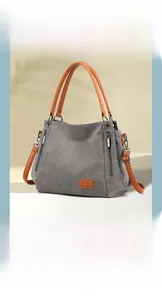 Close-up of grey canvas tote bag showing durable fabric and brown leather handle details