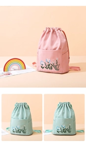 Detail of floral embroidery on pink and mint green waterproof drawstring backpacks