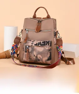 Detail of brown oxford backpack with vintage lettering and geometric woven strap