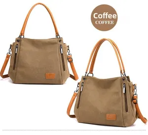 Close-up of coffee canvas tote bag with brown leather handles and silver zipper details