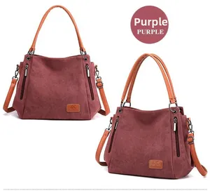 Close-up of deep purple canvas tote bags with leather handles and side zipper details