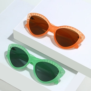 Fashionable cat eye sunglasses with rivet texture in orange and green translucent frames