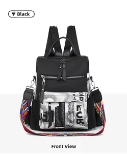 Detail of black nylon backpack featuring newspaper print pocket and ethnic strap