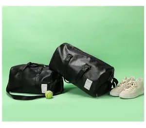 Detailed view of black PU leather duffel bag with shoe compartment and tennis equipment