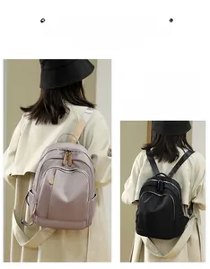 Detail of oxford fabric backpack showing light purple and black options with versatile straps