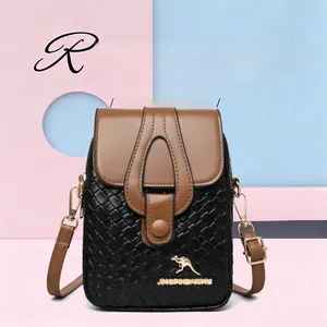 Detail of black woven texture and brown leather flap with golden kangaroo logo