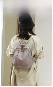 Lilac purple oxford fabric backpack with waterproof material shown on female model