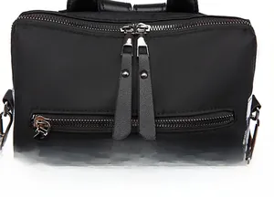 Macro detail of high-quality smooth double metal zippers on the black oxford travel backpack
