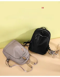 Detail of shell bag showing durable oxford fabric with multi-zipper pocket design