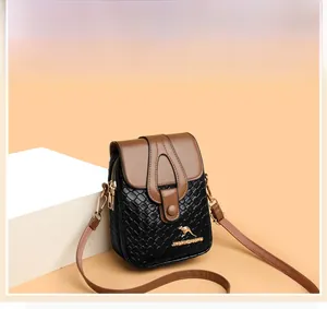 Close-up of two-tone PU leather crossbody bag with woven texture and kangaroo gold logo