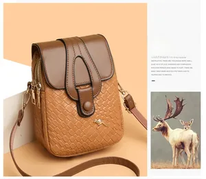 Detail of brown PU leather crossbody bag with woven texture and gold kangaroo logo charm