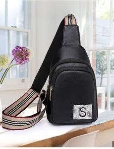 Detail of black pebbled PU leather chest bag with multi-layer zippers and vintage strap