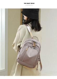 Side view of a light purple Oxford cloth backpack shown on a model for travel