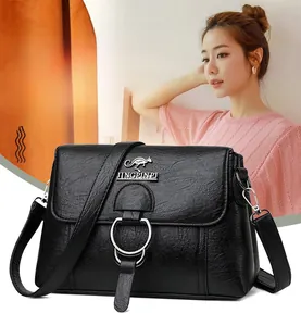 Close-up of black PU leather bag with magnetic flap and circular kangaroo logo emblem