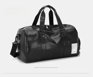 Detail of black faux leather travel bag with lychee texture and adjustable strap