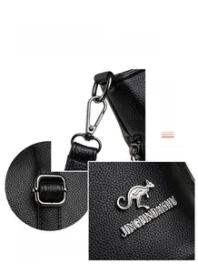 Detailed macro view of black lychee grain texture and metal buckle on women's bag