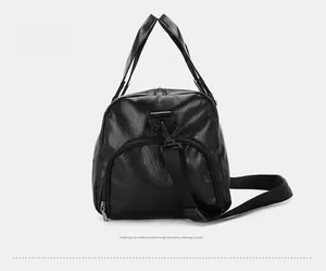 Detail of travel bag showing side pocket and textured black leather surface