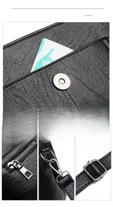 Detail of black leather shoulder bag with lychee texture and silver metal hardware