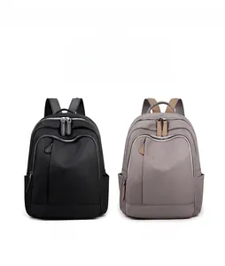 Parallel view of black and khaki nylon backpacks with dual zippers and side pockets