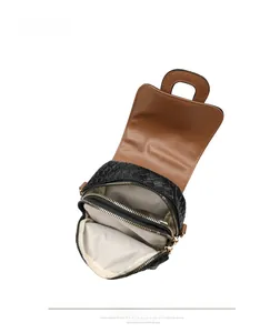 Detail view of woven leather bag showing dual zip compartments and beige chevron lining