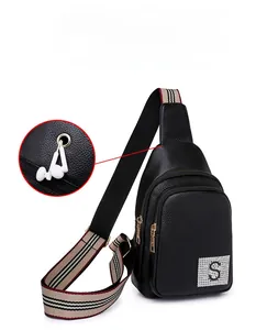 Detail of PU leather chest bag featuring an external headphone jack and stripe strap