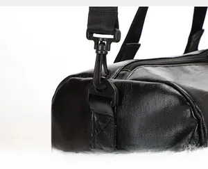 Close-up of durable metal swivel hook and reinforced stitching on black leather travel bag