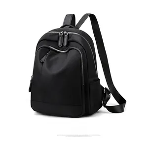 Side view of black oxford fabric backpack showing multi-layer storage and side pockets
