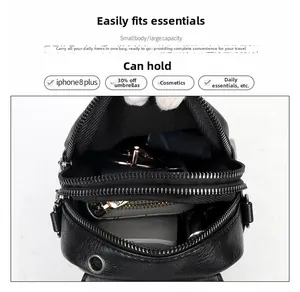 Detail view of large capacity black pebbled leather crossbody bag with multi-layer zippers