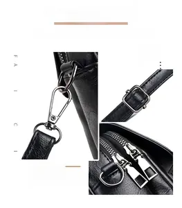 Detail of silver hardware on black PU leather bag showing zippers and strap hooks