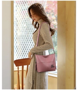 Detail of pink PU leather crossbody bag with lychee texture and tassel pendant