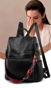 Close-up of black PU leather backpack featuring a colorful geometric woven strap