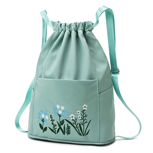 Mint green waterproof oxford backpack featuring floral embroidery and drawstring closure