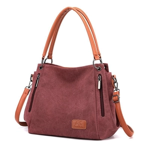 Classic burgundy canvas tote bag with brown faux leather handles and adjustable shoulder strap