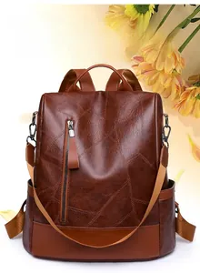 Close-up of dark brown PU leather backpack with geometric stitching and wide strap