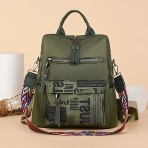 Fashionable dark green oxford backpack for women with colorful woven strap and graffiti detail