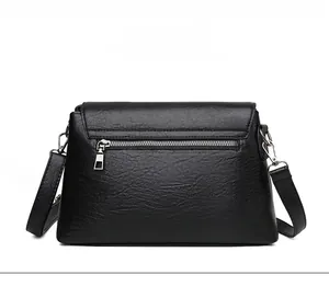 Back view of black large crossbody bag with lychee texture and metal zipper pocket