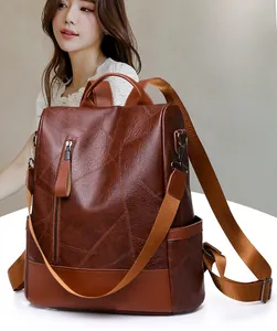 Detail view of brown soft PU leather backpack with vintage texture and stitch details