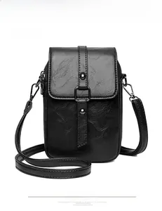 Detailed front view of black mini crossbody bag with retro oil wax leather texture and metal buckle