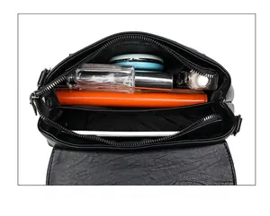 Macro view of the spacious inner compartments of the black PU leather shoulder bag