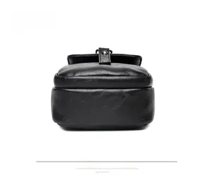 Detailed view of black retro textured PU leather flap with a dark gray metal buckle closure