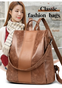 Close-up of brown litchi grain leather backpack with embossed logo and metal hardware detail