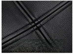 Detailed macro view of high-quality black PU leather with precise stitching craftsmanship