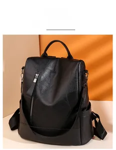 Detail of black faux leather backpack featuring lychee texture and vertical front zipper