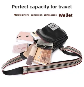 Capacity display of black pebbled PU leather chest bag with a striped strap and rhinestone S