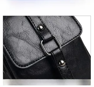 Close-up of black litchi pattern PU leather with square metal buckle and stud detail