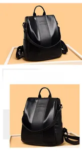 Detail of the black PU leather backpack showing fine grain texture and embossed logo
