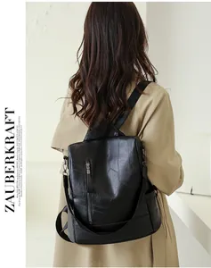 Detail of a large capacity black soft PU leather anti-theft backpack worn by a model