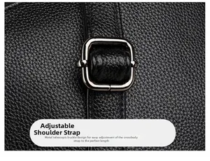 Detailed close-up of adjustable shoulder strap with black metal buckle on leather bag